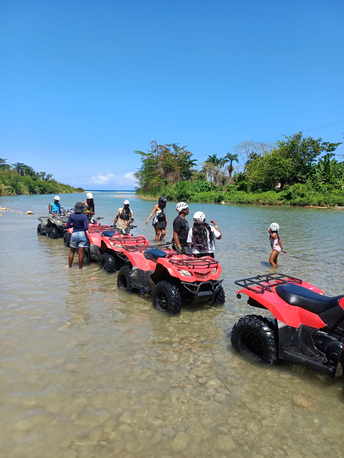 Guests enjoying an ATV excursion in a Jamaican river