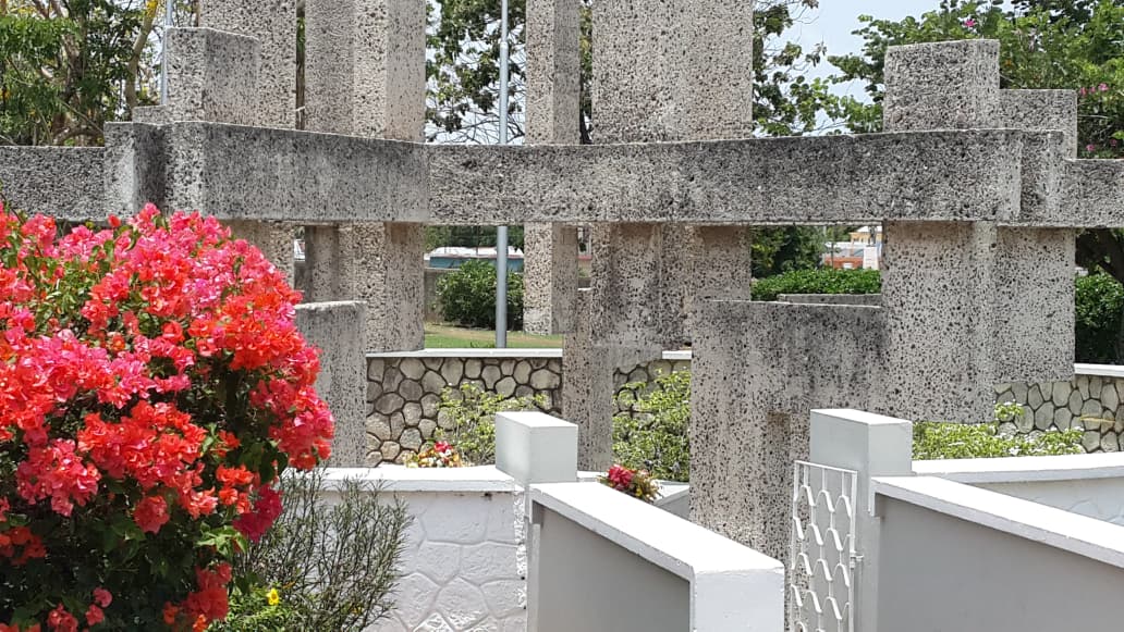 Stone memorial and tropical flowers